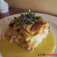Green Spinach Lasagne with layers of Shrimps and Salmon on Saffron Sauce